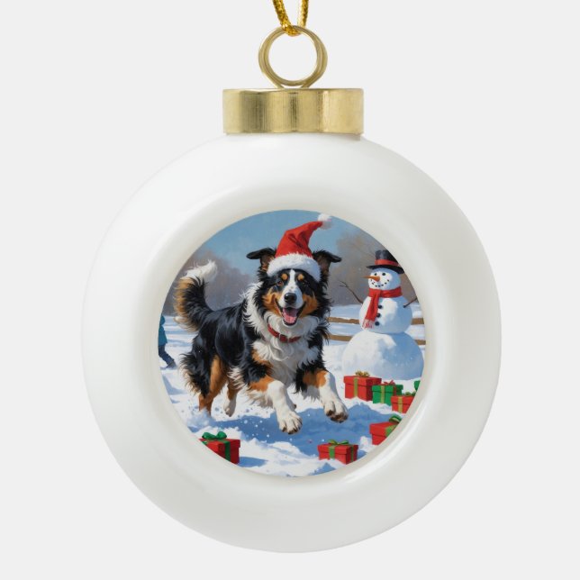 Rough Collie Running in Snow with Christmas Hat Ceramic Ball Christmas Ornament (Front)