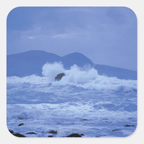 rough seas crashing against a rocky shore square sticker