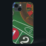 Roulette Table with Chips and Wheel iPhone 13 Case<br><div class="desc">The spinning wheel holds all the power on the roulette table, but the power of this painting is in the lifelike depiction of a casino scene. The green of the felt and the color of the chips puts you at the table, waiting on your bet to pay off. Be sure...</div>