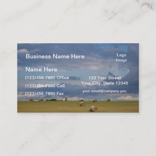 Round bales in a field by silo business card