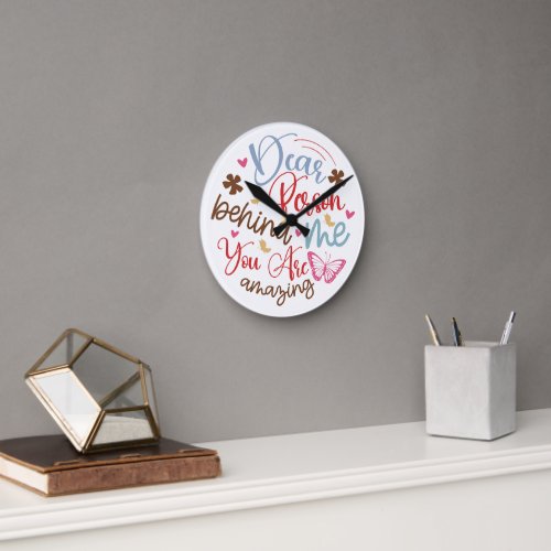 Round wall clock with a motivational phrase