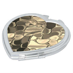 Rounded shapes in bronze color, glossy light gold? compact mirror