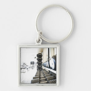 Row of free weights in foreground and exercise keychain