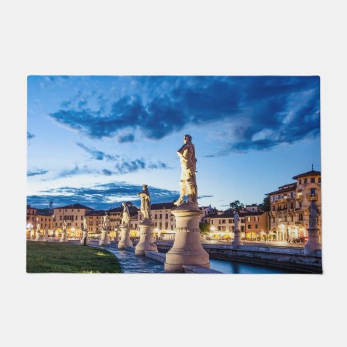 Row of illuminated statues in Padova Doormat