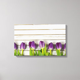 row of purple tulips on wood canvas print