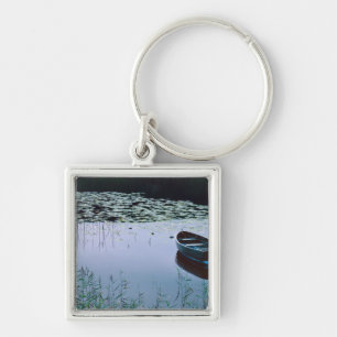 Rowboat on small lake surrounded by water keychain