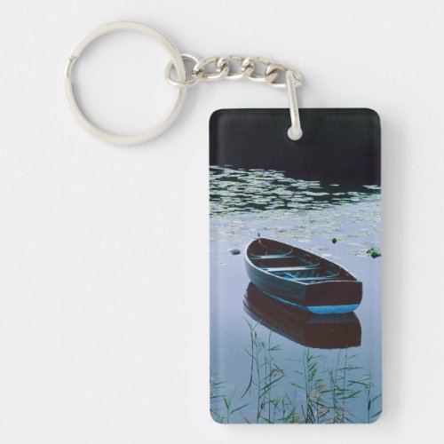 Rowboat on small lake surrounded by water keychain