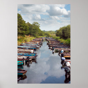 rowing boats moored at ross castle in killarney co poster
