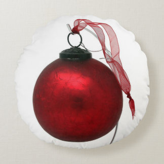 Ruby-red crackle glaze ornament with ribbon round pillow