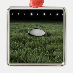 Rugby ball sitting on the grass pitch metal ornament
