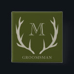 Rustic Army Green Antler Custom Groomsmen Gift Button<br><div class="desc">Introducing our exquisite groomsmen's button, a thoughtful token for honoring your wedding party. Crafted with meticulous attention to detail, this button features a sophisticated design with a touch of rustic charm. The army green background, adorned with soft amber/beige antler motifs and personalized monogram initials, adds a personalized touch to your...</div>