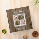 Rustic Barn Wood Calligraphy Photo Wedding Album 3 Ring Binder<br><div class="desc">Rustic or country wedding theme design featuring a square photo in a white shabby chic frame on a brown barn wood background. The words "Our Wedding" appear in modern white calligraphy style script on the cover, with the bride and groom's names and wedding date below in a smaller sans serif...</div>