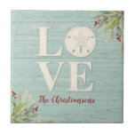 Rustic Beach Sand Dollar Ceramic Tile<br><div class="desc">A beach themed ceramic tile with the word love, and personalized with your name underneath. A sand dollar seashell creates the "o" in the word love. This coaster has a weathered textured wood background and the corners are decorated with sea grasses. This sand dollar ceramic tile is a great addition...</div>