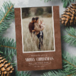 Rustic Brown Winter Christmas Single Photo Holiday Card<br><div class="desc">This simple and rustic holiday design features your best portrait photo over a rustic paper texture in brown color and the word "Merry Christmas" in vintage script text . Perfect for farmhouse style greeting cards. Easily add your best photo, your family names and year using the template. Add a personal...</div>