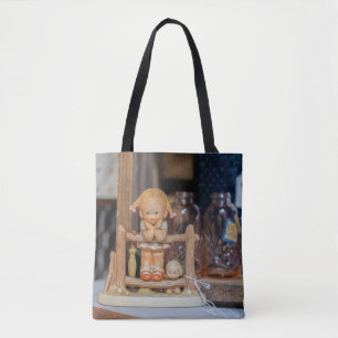 Rustic Charm: Ceramic Doll on a Swing Tote Bag