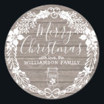 Rustic Country Merry Christmas White Holly Wreath Classic Round Sticker<br><div class="desc">Very pretty rustic Merry Christmas sticker. A light wood grain pattern provides the background. The entire design is surrounded by a modern white holly wreath. Merry Christmas is written in a large white script font. The name is written in a simple text font. A mason jar at the bottom adds...</div>