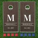 Rustic Dark Brown Wood Custom Wedding Monogram Cornhole Set<br><div class="desc">Elegant and minimalistic custom monogrammed cornhole yard game set features classic white monogram text that can be personalized with a last name initial, last name, and year established (married). A beautiful keepsake for and after the wedding day. A dark brown faux walnut wood grain background adds a rustic textured look...</div>
