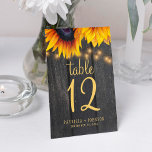 Rustic elegant sunflower fall wedding table number<br><div class="desc">Rustic country elegant wedding table number with editable text featuring big sunflowers and a chic gold script on a dark brown barn wood background with string lights. Ideal for your summer or autumn fall garden backyard outdoor or farmhouse wedding.</div>