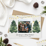 Rustic Family Photo Christmas Tree Farm Wood Holiday Card<br><div class="desc">Elegant "We wish you a Merry Christmas!" holiday photo card design features a rustic chic winter scene from a Christmas tree farm that frames a favorite family photo. Includes a white wood grain background with hanging string twinkle lights and fresh-cut green watercolor pine trees. Personalize with your choice of greeting,...</div>