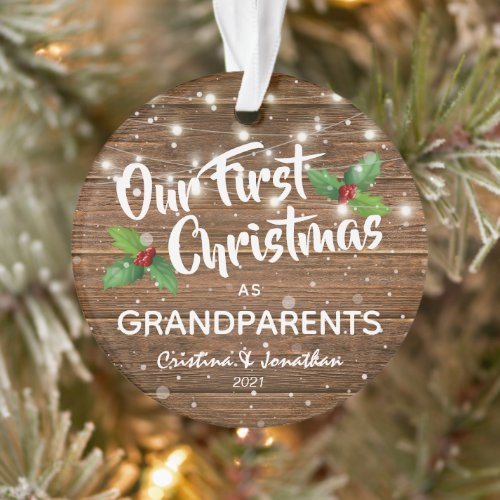 Rustic Grandparents First Christmas Photo Ornament - Surprise your parents with this sentimental our first christmas as grandparents tree ornament featuring a rustic wooden background, holly, snowflakes, string lights, their names, and the year. On the reverse is a precious photo of your grandchild.