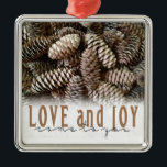 Rustic Holiday Love and Joy Pine Cone Metal Ornament<br><div class="desc">Festive,  rustic pine cones accentuate this classic,  elegant design wishing holiday Love and Joy.</div>
