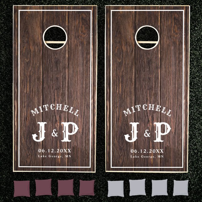 Rustic Initial Monogram Family Name Wedding Summer Cornhole Set (Two wooden cornhole boards with "Mitchell" and "J & P" text, set on grass, maroon and gray bean bags)