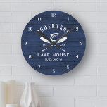 Rustic Lake House Family Name Blue Wood Round Clock<br><div class="desc">Add a personalized touch to your family lake house or mountain lakeside cottage with this rustic clock,  featuring crossed oars and a jumping fish on a rustic navy blue wood background,  with family name,  lake house location and established date in easy to use text templates.</div>