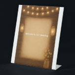Rustic Mason Jar & String Lights Wedding Tabletop  Pedestal Sign<br><div class="desc">Add rustic charm to your reception with this tabletop sign featuring glowing mason jar string lights and a wood-style background. Perfect for barn weddings, farmhouse receptions, or country-chic celebrations, this sign works beautifully on dessert tables, gift tables, guest book stations, or bar areas. A simple and stylish way to decorate...</div>