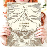 Rustic Mountain Landscape Custom Name Planner<br><div class="desc">This charming design features a hand-drawn mountain landscape with intricate details of ferns, mushrooms, and a winding river, all in earthy brown tones. The personalized name and year add a thoughtful touch, making it perfect for nature lovers and adventurers. Ideal for journaling, goal-setting, or daily planning with an inspiring and...</div>