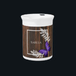 Rustic Purple Butterfly Beverage Pitcher<br><div class="desc">Serve your hot or cold beverages with this unique Rustic Purple Butterfly Personalized Porcelain Pitcher. Pitcher design features a vibrant butterfly resting on delicate foliage with a space to add your name against a rustic wooden background. Additional gift items available with this design as well as a variety of colors....</div>