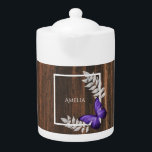 Rustic Purple Butterfly Teapot<br><div class="desc">Enjoy your tea with a Rustic Purple Butterfly Personalized Teapot. Teapot design features a vibrant butterfly resting on delicate foliage with a space to add your name against a rustic wooden background. Additional gift items available with this design as well as a variety of colors.</div>