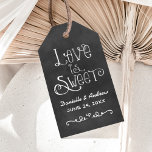 Rustic Script Chalkboard Wedding Love is Sweet Gift Tags<br><div class="desc">Charming chalkboard cardstock favor tags feature "Love is Sweet" with a custom wedding monogram in handwritten style fonts with a heart and scroll design accent that have a white chalk appearance. Background has a rustic black board textured appearance.</div>