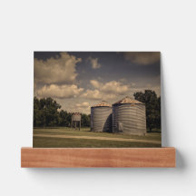 Rustic Silos in a Sleepy Scene Under Fluffy Clouds
