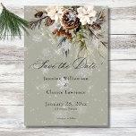 Rustic Snowfall Pine & White Floral Sage Wedding Save The Date<br><div class="desc">Envelop your guests in the serene beauty of winter with our exquisite wedding save the date card. A calming dusty sage backdrop creates a peaceful canvas for a stunning arrangement of fresh green pine sprigs, soft cream-colored blooms, and rustic brown pinecones. This natural masterpiece is adorned with a delicate snowfall...</div>