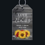 Rustic Sunflower Red Rose Thank You Wedding Favor Gift Tags<br><div class="desc">Sunflower rose rustic wedding favor tags that can be easily personalized for your big day or bridal shower. The elegant watercolor design features yellow gold sunflowers (or daisies) and burgundy red roses with baby's breath and greenery, illuminated by string lights over a vintage country gray barn wood. In white brush...</div>