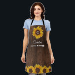 Rustic Sunflowers Monogram Wood Kitchen Apron<br><div class="desc">This apron design features pretty painted, watercolor sunflowers on a rustic wood background. Click the customize button for more flexibility in modifying the text. Variations of this design, different paper types, as well as coordinating products are available in our shop, zazzle.com/store/doodlelulu. Contact us if you need this design applied to...</div>