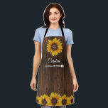 Rustic Sunflowers Monogram Wood Kitchen Apron<br><div class="desc">This apron design features pretty painted, watercolor sunflowers on a rustic wood background. Click the customize button for more flexibility in modifying the text. Variations of this design, different paper types, as well as coordinating products are available in our shop, zazzle.com/store/doodlelulu. Contact us if you need this design applied to...</div>