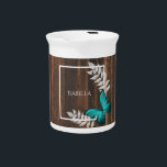 Rustic Teal Butterfly Beverage Pitcher<br><div class="desc">Serve your hot or cold beverages with this unique Rustic Teal Butterfly Personalized Porcelain Pitcher. Pitcher design features a vibrant butterfly resting on delicate foliage with a space to add your name against a rustic wooden background. Additional gift items available with this design as well as a variety of colors....</div>
