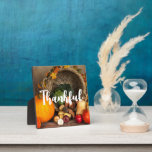 Rustic Thanksgiving Table Bountiful Harvest Plaque<br><div class="desc">A photo plaque with a photograph of a thanksgiving harvest,  set on a rustic wooden table. Pumpkin,  potatoes,  squash etc...  make up this bountiful collection of food. Colorful autumn leaves surround the cornucopia basket.</div>