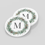 Rustic Winter Greenery Monogram Initial Wreath Round Paper Coaster<br><div class="desc">Elegant round white holiday drink coaster design features a rustic chic white wood grain background with a wreath of winter watercolor greenery framing a family / last name monogram initial. Includes a white background color.</div>