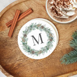 Rustic Winter Greenery Monogram Initial Wreath Round Paper Coaster<br><div class="desc">Elegant round white holiday drink coaster design features a rustic chic white wood grain background with a wreath of winter watercolor greenery framing a family / last name monogram initial. Includes a white background color.</div>