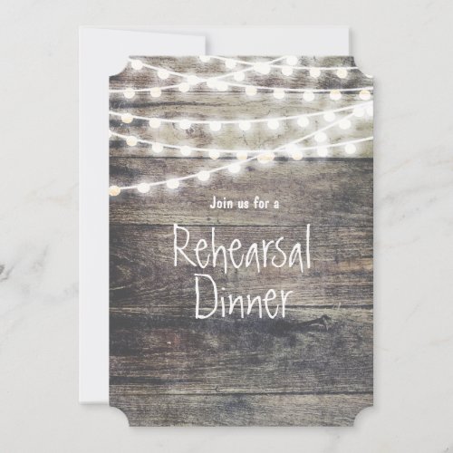 Rustic wood and string lights rehearsal dinner invitation