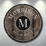 Rustic Wood Family Name  Dart Board<br><div class="desc">This rustic dartboard is the perfect addition to your family beach house, lake house, game room, man cave, and more. It features a bold initial monogram at the center, with your family name proudly displayed at the top. The bottom reads "Beach House, " but this can be customized to fit...</div>