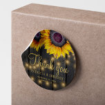 Rustic wood sunflower wedding thank you favor classic round sticker<br><div class="desc">Editable text wedding thank you sticker featuring rustic big beautiful sunflowers on a dark brown barn wood background with string lights. Ideal for your summer or autumn fall elegant rustic country outdoor backyard or farmhouse wedding.         Personalize it with the bride's and groom's names and wedding details!</div>