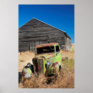 Rusting car in front of abandoned farm poster