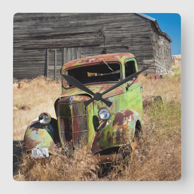 Rusting car in front of abandoned farm square wall clock (Front)