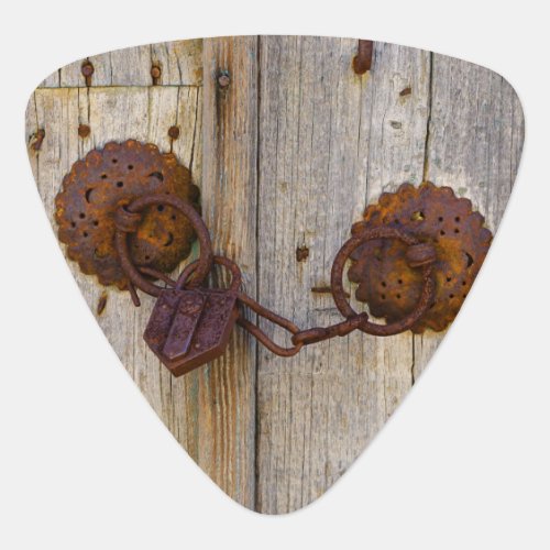 Rusty vintage old iron padlock on a wooden door  guitar pick