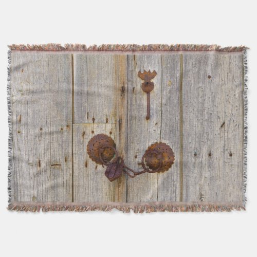 Rusty vintage old iron padlock on a wooden door  throw blanket