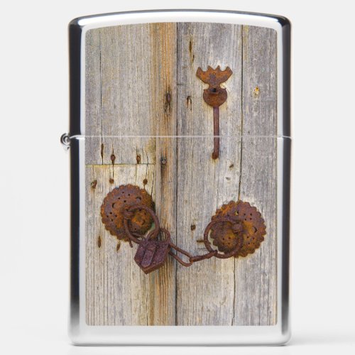 Rusty vintage old iron padlock on a wooden door  zippo lighter