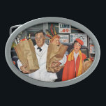 Sack Full of Trouble Oval Belt Buckle<br><div class="desc">Artist: Richard Sargent | Exasperated clerk carrying boy out of store in sack</div>